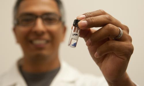 Arturo Gutierrez shows a sample of his research on lithium ion batteries.