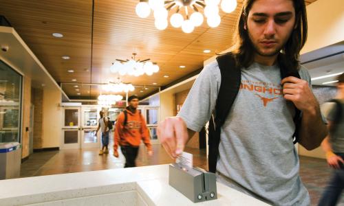 Student swiping identification card