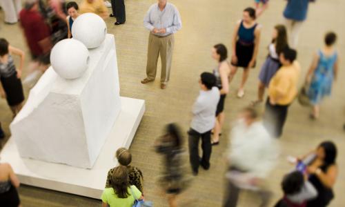 Visitors surround Louise Bourgeois' sculpture "Eyes."