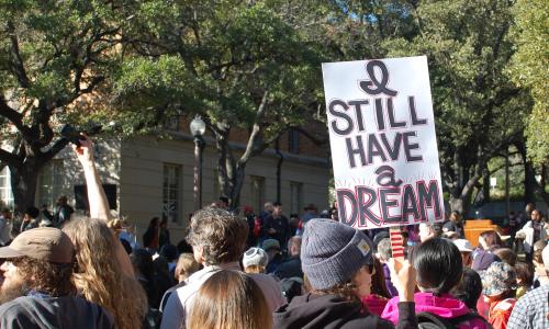 Student holding sign saying "I still have a dream" on MLK Day