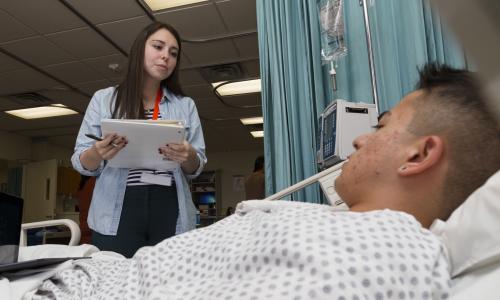 Social work health services with patient in hospital.