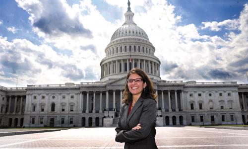  LBJ Alumna Jennifer Poulakidas in front of capitol