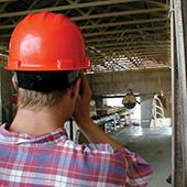 Architect wearing hard hat on construction site.