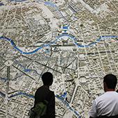 Students examining large map of city.