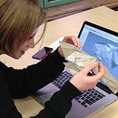 Student examines geometric model.