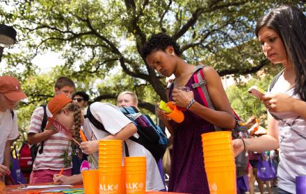 Students browsing student organization tables at Party on the Plaza