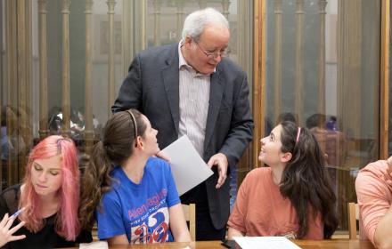 Faculty member talking with students.